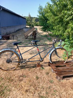 a bike that is parked next to a wooden bench