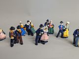many figurines of people that are standing together