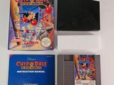 an old nintendo game is sitting on a table next to a book