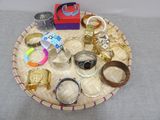 a tray with a variety of rings and bracelets on it