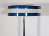 a blue and white table lamp with a chrome base