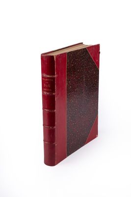a red book that is sitting on a white surface