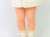 an image of a doll with a white dress and white shoes