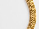 a gold necklace with a chain that has a clasp on it