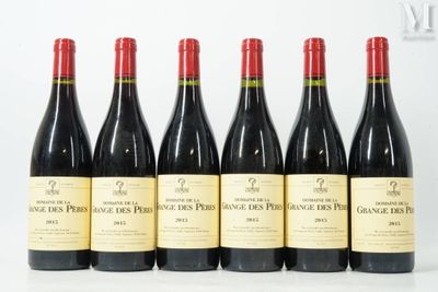 six bottles of red wine are lined up on a table
