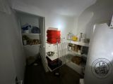 an image of a small kitchen with a lot of shelves