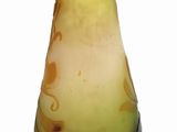 a yellow vase with a black base on a white background