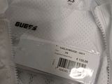 the back of a white shirt that has a tag on it