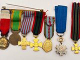 many medals and medals on display on a white surface