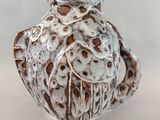 un vase blanc orné d'un motif marron et blanc