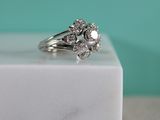 an image of a diamond ring sitting on a marble block