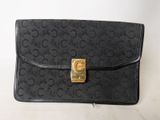 an image of a black purse with a gold clasp