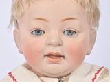 a baby doll with blonde hair and blue eyes