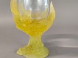 a glass vase with a yellow flower inside of it