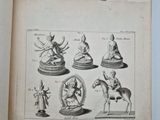 an open book with a drawing of various statues on it