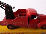 a red toy truck with a crane on top of it