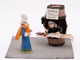 a figurine of a woman standing next to a barrel of wine