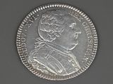a close up of a silver coin with a portrait of a man