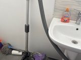 a small bathroom with a sink and a vacuum in it