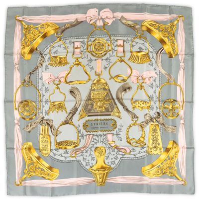 a square scarf with a gold and grey design