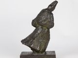 a bronze statue of a man with a hat on his head