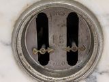 a white marble clock with a hole in the middle