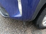 a close up of a car ' s front bumper and tire