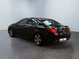 the back end of a black car in a white room