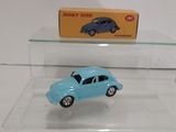 a small blue toy car on display in a glass case
