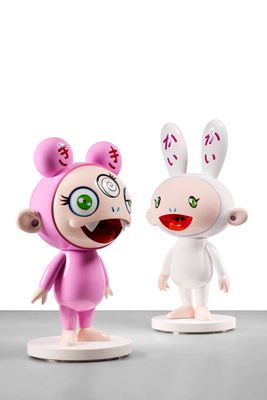 two figurines of cartoon characters standing next to each other