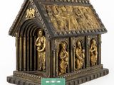 a gold statue of a church with a green card