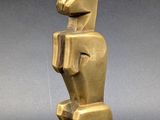 a gold statue of a rabbit on a pedestal on a gray background