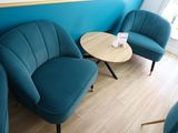 three chairs and a table in the corner of a room