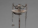 a metal object with chains hanging from it ' s neck