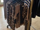 a rack with clothes on it in a clothing store