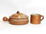 two brown pottery pots and a cup on a white surface