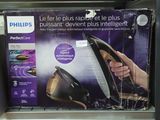 a box with a picture of a person holding a black and gold steam iron