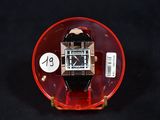 a watch that is sitting on top of a red object