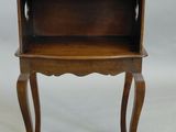 an old wooden table with a shelf on top of it
