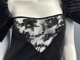 a close up of a mannequin wearing a black and white dress