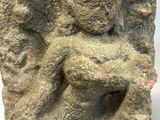 an image of a stone statue of a man holding a baby