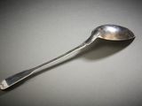 a silver spoon with a spoon handle on a table