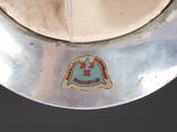a close up of a hat on a metal plate