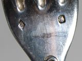 a close up of a fork with holes in it