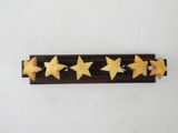four star shaped cookies are arranged on a wooden rack on a white surface