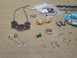 a lot of jewelry that is laying out on the floor