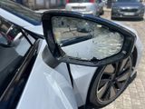 a side view mirror of a car with a broken windshield