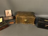 three small wooden boxes and a small wooden box on a gray surface