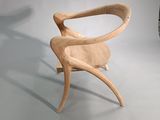 a wooden chair that is sitting on a white floor