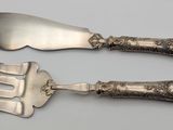 two forks and a knife that are on a table
